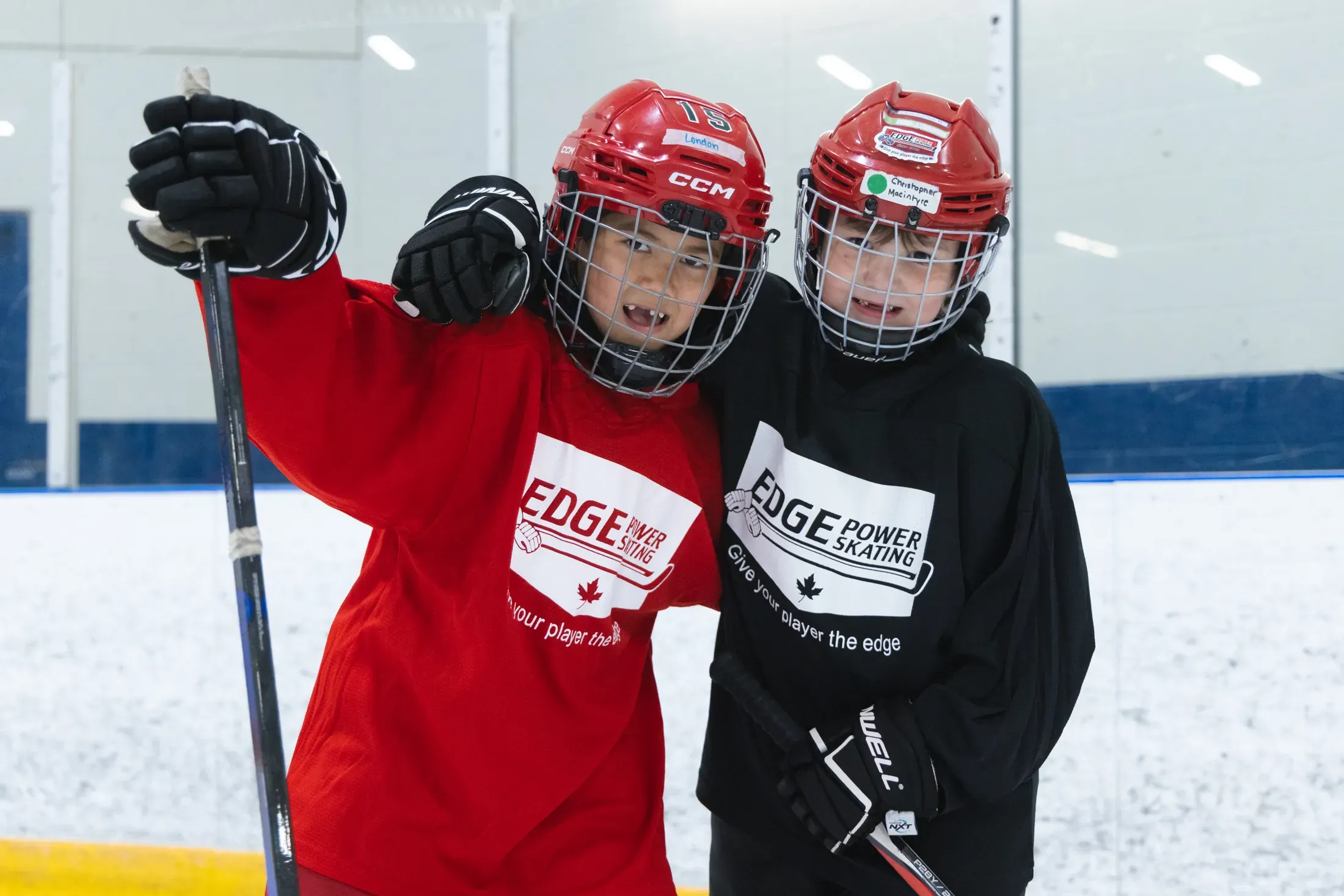 Edge coaches working a busy drill line — repetition, fundamentals, energy